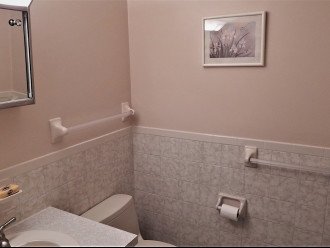 Hall bathroom, tiled floor, tiled wall surround.