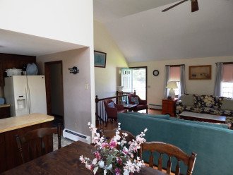 Open living room, dining room, kitchen areas, open stairway to lower level