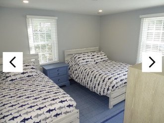 Bedroom with full bed, twin bed, large closet and smart TV