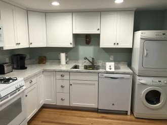 Full service kitchen and stackable laundry