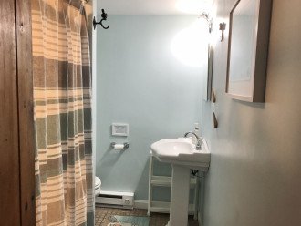 Well-organized bathroom with shower.