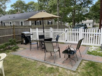 Patio with tables, chairs, and grill