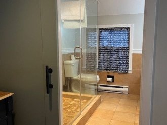 Large glass tiled shower in upstairs bathroom